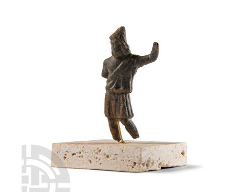 1st-2nd century A.D.. Standing wearing a tunic draped from the left shoulder and a conical hat, left arm extended at shoulder