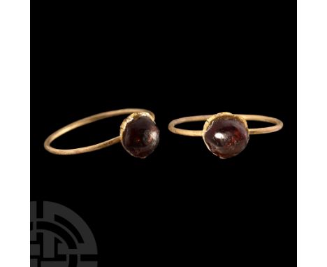12th-15th century A.D.. With slender hoop, cup bezel with inset cabochon garnet. Cf. Oman, C.C., British Rings 800-1914, Lond