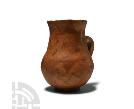 Circa 6th century B.C. Redware cup with rounded underside to the body, conical shoulder, short neck and gently flared rim; st