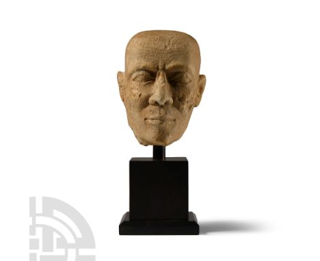 Ptolemaic Period, 332-31 B.C. or later. With shaven head, finely modelled facial features, lined forehead; mounted on a custo