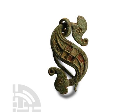 1st-2nd century A.D.. Plaque with scaphoid terminals formed as head and tail of an S-curved beast, body comprising chequerboa
