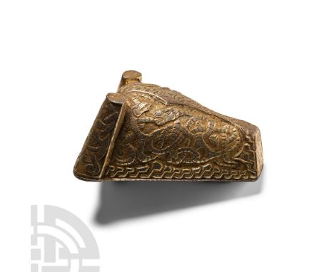 Circa 9th-11th century A.D.. Richly decorated and with an applied backplate; the body of the brooch formed as a hollow-cast c
