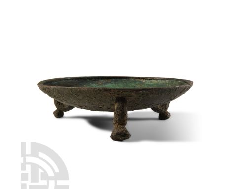 Circa 1st-3rd century A.D.. Broad dish with carinated rim, three legs to the underside, each a C-shaped shank with a bun foot