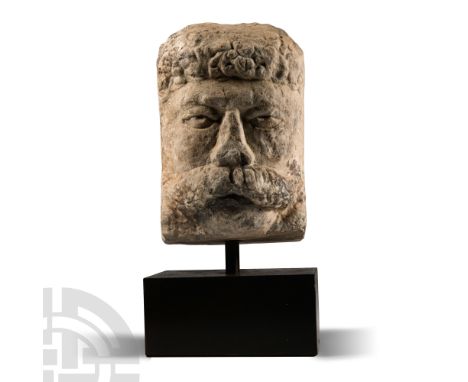 1st-2nd century A.D.. Carved with comma-leaf detailing to the hair, a low brow over almond-shaped eyes, broad triangular nose