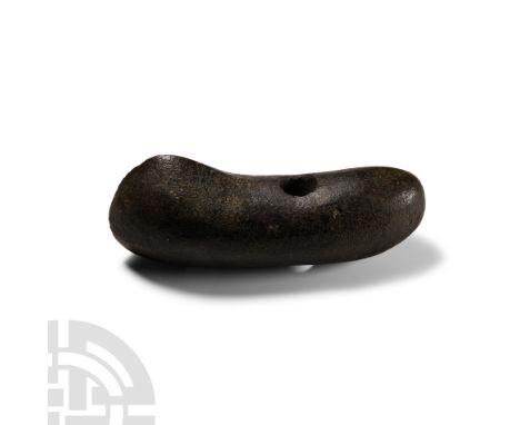 Neolithic Period, late 3rd-early 2nd millennium B.C. A finely polished boat-shaped axe in dark grey stone, with expanded asym