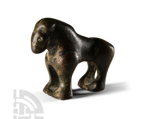 Circa 11th-12th century B.C. Modelled in the round with stocky body, front and back legs united with an integral pedestal. Cf