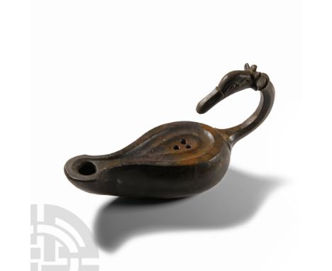 Circa 1st century A.D.. Hollow-formed piriform lamp with D-shaped nozzle and small spout, recessed upper face with three pier