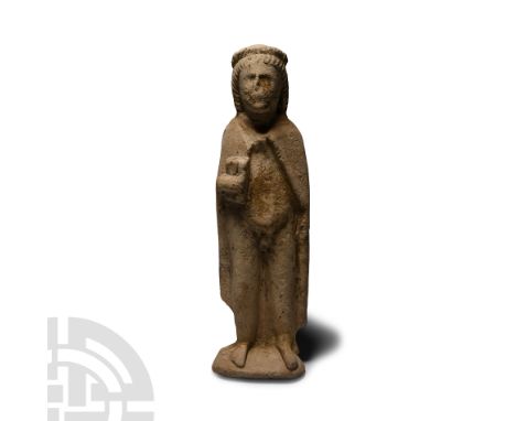 Circa 4th-3rd century B.C. Modelled in the half-round, standing nude male with mantle to the shoulders, clutching a codex in 