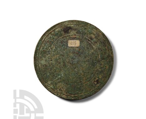 1st-2nd century A.D.. Discoid plaque with one polished face, slightly raised rim, incised concentric rings, old label '235' t