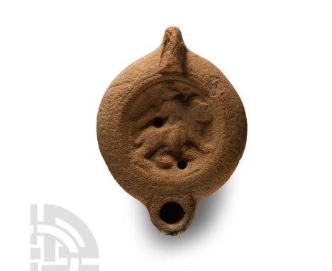 2nd-3rd century A.D.. Lug handle to the rear, shallow discus with filling holes and a low-relief image of goddess Cybele ridi