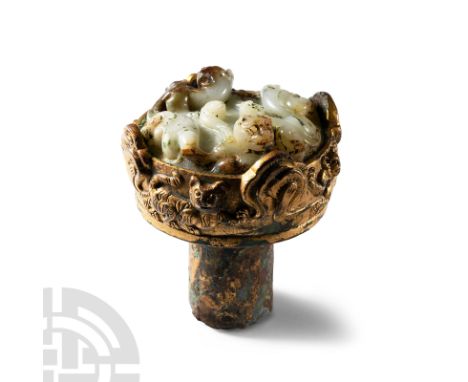 Han Dynasty, 2nd century B.C.-1st century A.D.. Comprising a discoid body and cylindrical socket pierced twice for attachment