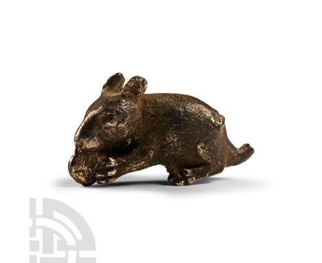 1st-2nd century A.D.. Modelled in the round, with disc (biscuit?) held in the forepaws. Cf. Christie's, London, A Peaceable K