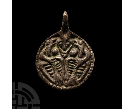 Circa 9th-10th century A.D.. With integral loop, border enclosing a low-relief image of a male facing mask between two birds 