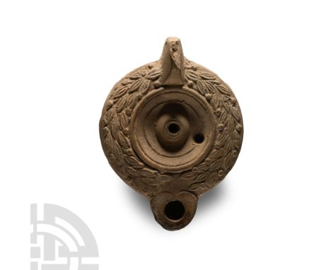 2nd-3rd century A.D.. Lug handle to rear, deep discus with a dome filling hole, another filling hole to the side; wide should