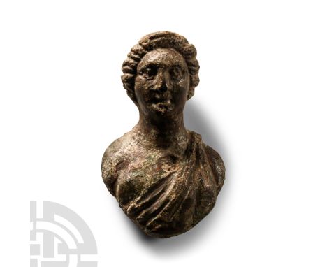 Circa 2nd-3rd century A.D.. Modelled in the half-round with a dressed hair and stylised facial features; bare-chested except 