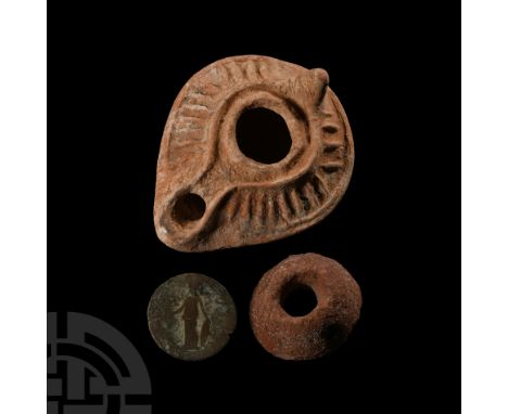 Circa 1st-5th century A.D.. A trio of artefacts comprising: a Roman copper-alloy coin, likely a sestertius, with worn designs