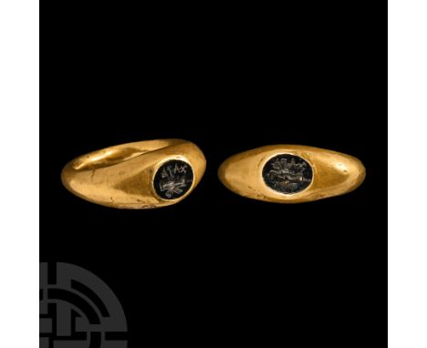 2nd century A.D.. Comprising a hollow-formed hoop with rounded shoulders, inset garnet intaglio with clasped hands and 'AIAX'
