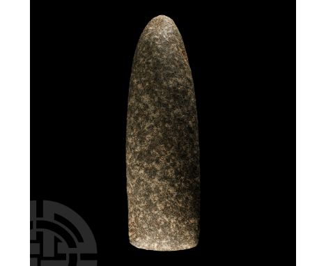 Neolithic Period, circa 6th-4th millennium B.C. An axehead or chisel with cylindrical body, conical butt and broad straight e