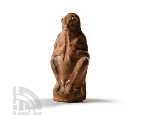 5th-4th century B.C. Modelled in the half-round, hollow to the underside; Satyr shown crouching, nude, playing an aulos, a do
