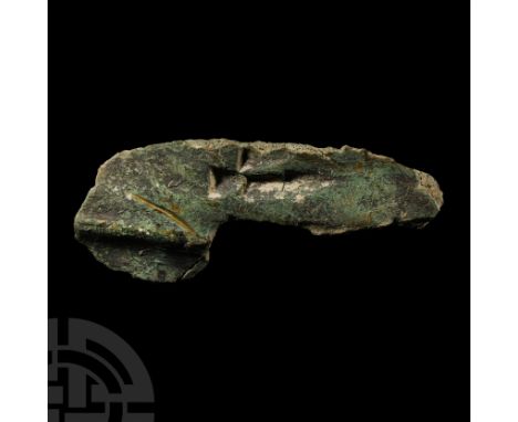 2nd-1st millennium B.C. Irregular ingot fragment from a founder's hoard with carination and triangular scars to one face. Cf.