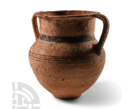 Late Bronze Age, circa 850-600 B.C. Squat unglazed vessel with conical body, narrow shoulder, broad tubular neck and everted 