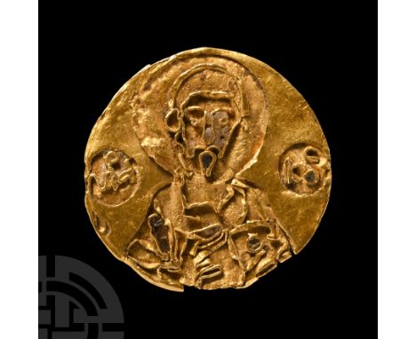 Late 10th-early 11th century A.D.. Sheet gold disc with applied filigree cells; facing nimbate saint with flanking roundels b