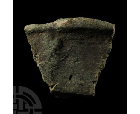 2nd-1st millennium B.C. Irregular bronze ingot fragment with lip to one curved edge. Cf. similar (but smaller) items in a Bro