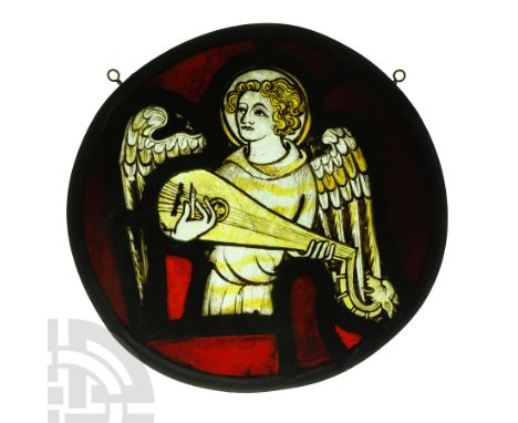 Early 14th century A.D.. Roundel with painted image of a winged and nimbate angel playing a gittern; left hand supporting the