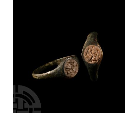 Circa 1st century B.C. A Henig Type I ring circular in shape set with a chalcedony intaglio decorated with Victory standing i