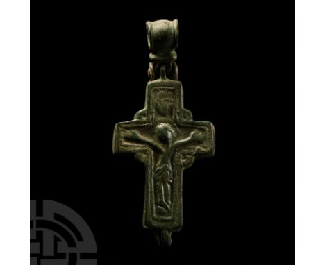 Circa 12th century A.D.. Two-piece enkolpion with hinged suspension loop, to each face a low-relief Corpus Christi with facin