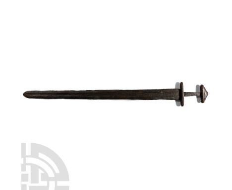 8th-9th century A.D.. Pattern-welded, double-edged tapering blade with a tapering tang; the boat-shaped lower guard, pommel, 