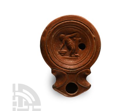 1st-2nd century A.D.. Comprising a shallow discus framed by concentric lines, low-relief image of a standing male reaching fo