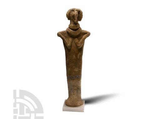 1500-500 B.C. Standing female deity (Astarte?), wearing a long cloak and two broad necklaces; arms bent and hands placed on t