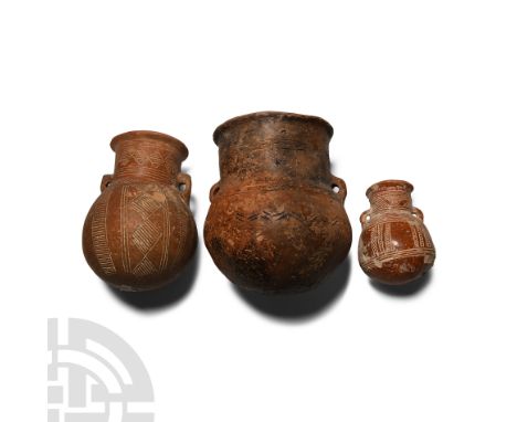 Middle Bronze Age, circa 2000-1600 B.C. Comprising: two with globular body, broad neck and flared rim, pierced lugs to the sh