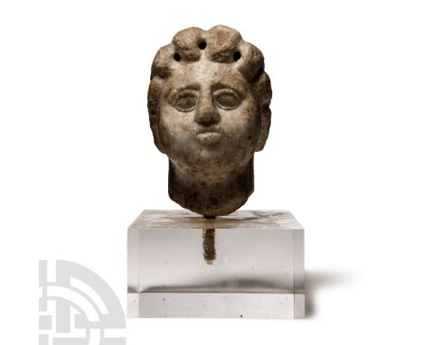 Circa 2nd century A.D.. Carved in the round with fleshy facial features, almond-shaped eyes and small pouting mouth; the hair
