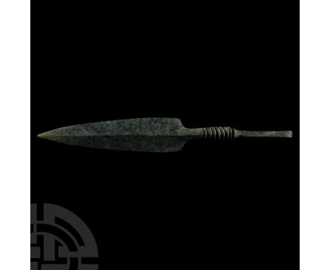 3rd-2nd millennium B.C. With long blade, shallow midrib, rectangular-section tang; engraved, reinforced shaft, and squared sh