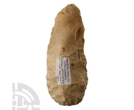 Neolithic Period, circa 8000-3000 B.C. Triangular in section with broad cutting edge, old collector's label 'Hache Taillée / 