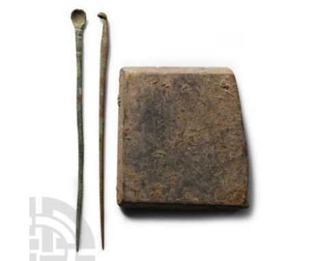 2nd-4th century A.D.. Sub-rectangular pallet with ground socket to one face; two cosmetic or scribal spoons.  47 grams total,