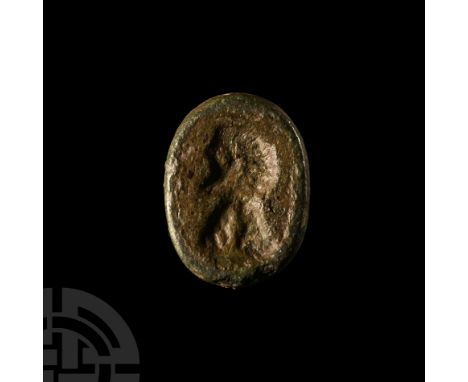 Circa 2nd century A.D.. Ellipsoid glass insert with profile portrait bust to one face.  2.11 grams, 14 mm (1/2 in.). Found UK