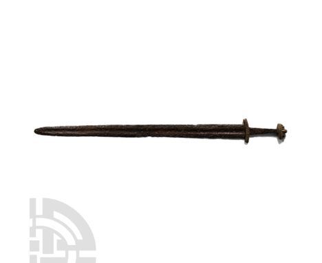 10th-13th century A.D.. With a double-edged tapering blade, long tapering fullers and a narrow tang; boat-shaped bronze cross