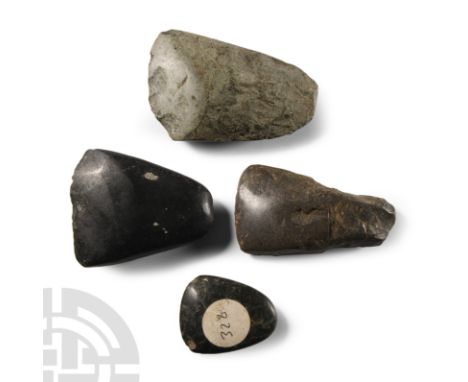 Neolithic Period, circa 4th-3rd millennium B.C. Group of four trapezoidal axeheads, each with a gently curved cutting edge.  