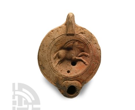 2nd century A.D.. With a lug handle to the rear, discus with a leaping long-horned ibex within a concentric circle border; co