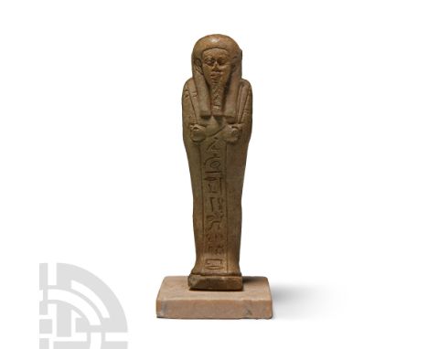 Late Period, 664-332 B.C. Olive-green faience with false beard, tripartite wig, holding a pick, hoe and seed bag; plain dorsa