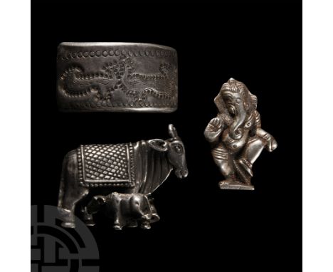 20th century A.D.. Mixed group of silver-coloured metal fittings including a hollow-formed model of the Nandi cow and calf, a