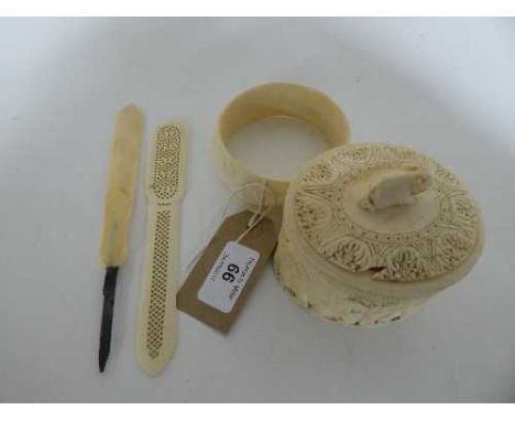 A carved bone trinket box depicting elephants, carved bangle, carved letter opener and bone handled knife 