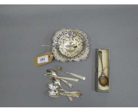 A silver pierced dish, together with six silver teaspoons, two silver pickle forks and silver spoon.