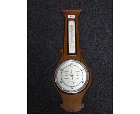 An inlaid mahogany barometer with silvered dial