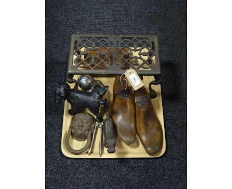 A pair of wooden shoe stretchers, metal trivet, cast metal Scottie dog door stop, dog nutcracker etc