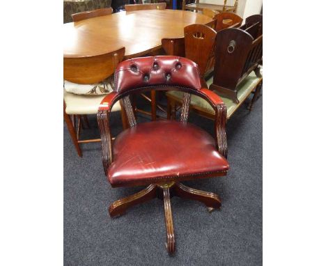 A red button leather swivel Captain's armchair  