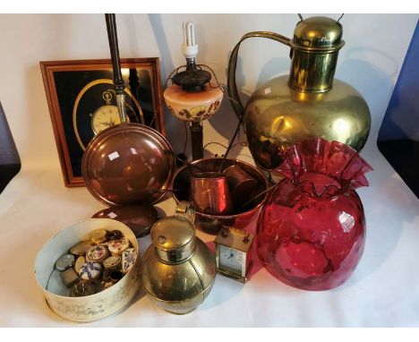 A converted Victorian oil lamp and cranberry shade together with various brass and copper, plated cutlery, a small glass and 